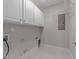 Utility room featuring tile floors and white cabinets at 103 Aisling Ct, Cary, NC 27513