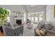 Bright living room with a fireplace, vaulted ceiling, and access to the outdoor area through glass doors at 103 Aisling Ct, Cary, NC 27513