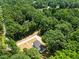Birds eye view of house surrounded by trees, showcasing privacy and access via a gravel driveway at 1065 Shuford Rd, Wake Forest, NC 27587