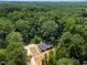 Expansive aerial view of a home nestled among dense trees, highlighting the property's private setting at 1065 Shuford Rd, Wake Forest, NC 27587