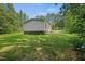Sprawling backyard surrounded by lush greenery, providing privacy and ample space for recreation at 1065 Shuford Rd, Wake Forest, NC 27587