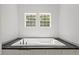 Bright bathroom with large soaking tub and double windows at 1065 Shuford Rd, Wake Forest, NC 27587