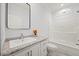 Bright bathroom features a shower-tub combo, granite countertops, and modern sink with a large mirror at 1065 Shuford Rd, Wake Forest, NC 27587