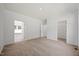 Spacious bedroom with neutral carpet, access to walk-in closet, and bright windows at 1065 Shuford Rd, Wake Forest, NC 27587