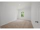Bedroom with carpet floors, a window, and a door at 1065 Shuford Rd, Wake Forest, NC 27587