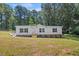 Charming single-story home featuring a welcoming front porch and landscaped yard at 1065 Shuford Rd, Wake Forest, NC 27587