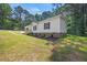 Well-maintained home with a brick foundation and lush green lawn at 1065 Shuford Rd, Wake Forest, NC 27587