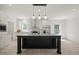 Spacious kitchen features stainless steel appliances, a black center island, and white cabinetry at 1065 Shuford Rd, Wake Forest, NC 27587
