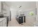 Bright kitchen with stainless steel appliances, stylish island with pendant lights, open to the living area at 1065 Shuford Rd, Wake Forest, NC 27587
