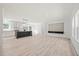 Bright and airy living room featuring wood-look floors, modern lighting, and an open layout at 1065 Shuford Rd, Wake Forest, NC 27587