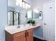 A bathroom with a large vanity, dual sinks, a walk-in shower, and white cabinets at 1103 Mallory Ln, Durham, NC 27713