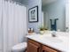 Bathroom includes a shower with curtain and decorative items on the sink and toilet at 1103 Mallory Ln, Durham, NC 27713