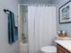 Bathroom with tub/shower combination and vanity with white sink and wood cabinet at 1103 Mallory Ln, Durham, NC 27713