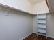 A closet with wooden floors, metal shelving and a wooden rod at 1103 Mallory Ln, Durham, NC 27713