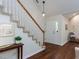 Inviting foyer with hardwood floors, staircase, and a view of the front door at 1103 Mallory Ln, Durham, NC 27713