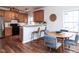 A kitchen and dining area with wooden cabinets, stainless steel appliances and seating for six at 1103 Mallory Ln, Durham, NC 27713