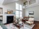 Bright living room featuring a fireplace, vaulted ceilings, and large windows that bring in natural light at 1103 Mallory Ln, Durham, NC 27713