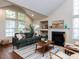 Spacious living room with a fireplace, large windows, and comfortable seating for relaxing and entertaining at 1103 Mallory Ln, Durham, NC 27713