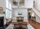 Open living space with vaulted ceilings, a fireplace, and a view of the dining area and second-floor balcony at 1103 Mallory Ln, Durham, NC 27713