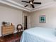 A main bedroom with a tray ceiling, windows, a large bed, a dresser and a closet at 1103 Mallory Ln, Durham, NC 27713