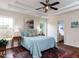 A main bedroom with a tray ceiling, windows, a large bed and ensuite bathroom at 1103 Mallory Ln, Durham, NC 27713