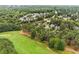 Aerial view of community, highlighting the lush greenery, mature trees, and manicured golf course at 1120 Colonial Club Rd, Wake Forest, NC 27587