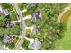 Aerial view of a home nestled in a wooded neighborhood with a well-maintained golf course nearby at 1120 Colonial Club Rd, Wake Forest, NC 27587