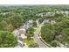 Aerial view of a neighborhood with lush greenery, mature trees, and winding streets at 1120 Colonial Club Rd, Wake Forest, NC 27587