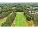 An aerial view of the golf course and surrounding lush green community, with mature trees at 1120 Colonial Club Rd, Wake Forest, NC 27587