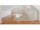Large attic with high ceilings, hardwood floors, chandelier, window and white banister at 1120 Colonial Club Rd, Wake Forest, NC 27587