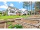 Spacious backyard with terraced garden beds, lush lawn, and inviting back porch at 1120 Colonial Club Rd, Wake Forest, NC 27587