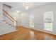 Elegant entryway featuring hardwood floors, a chandelier, and staircase at 1120 Colonial Club Rd, Wake Forest, NC 27587
