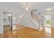 Elegant entryway featuring hardwood floors, a chandelier, and staircase at 1120 Colonial Club Rd, Wake Forest, NC 27587