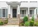 Inviting front entrance with stone steps and decorative landscaping features at 1120 Colonial Club Rd, Wake Forest, NC 27587