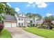 Charming two-story home with a manicured lawn and a two-car garage at 1120 Colonial Club Rd, Wake Forest, NC 27587