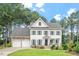 Charming two-story home with a manicured lawn and a two-car garage at 1120 Colonial Club Rd, Wake Forest, NC 27587