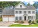 Charming two-story home with a manicured lawn and a two-car garage at 1120 Colonial Club Rd, Wake Forest, NC 27587
