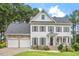 Charming two-story home with a manicured lawn and a two-car garage at 1120 Colonial Club Rd, Wake Forest, NC 27587