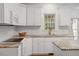 Modern kitchen featuring white cabinets, granite countertops, and stainless steel appliances at 1120 Colonial Club Rd, Wake Forest, NC 27587
