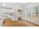 Bright kitchen with white cabinets, a kitchen island and access to an outdoor living area at 1120 Colonial Club Rd, Wake Forest, NC 27587