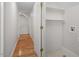 Hallway and laundry area with hardwood floors and a storage niche with shelving at 1120 Colonial Club Rd, Wake Forest, NC 27587