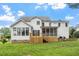 Exterior of home featuring a screened porch, deck, and beautifully landscaped yard at 1120 Colonial Club Rd, Wake Forest, NC 27587