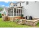 Back of home with screened in porch, patio area, and staircase at 1120 Colonial Club Rd, Wake Forest, NC 27587
