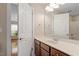 Well-lit bathroom featuring dual sinks, a large mirror, and modern fixtures at 1153 Litchborough Way, Wake Forest, NC 27587