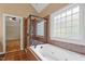 Bathroom with shower and bathtub; large window at 1153 Litchborough Way, Wake Forest, NC 27587