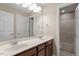 Well-lit bathroom features dual sinks, a large mirror, and a white door frame at 1153 Litchborough Way, Wake Forest, NC 27587