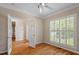 Bright bedroom with hardwood floors, white trim, and a ceiling fan at 1153 Litchborough Way, Wake Forest, NC 27587
