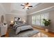 Bright bedroom with hardwood floors, tray ceiling, and large window at 1153 Litchborough Way, Wake Forest, NC 27587