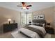 Comfortable bedroom featuring a ceiling fan, neutral walls and natural light from the windows at 1153 Litchborough Way, Wake Forest, NC 27587