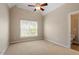 Bright bedroom showcasing a window, neutral walls and a ceiling fan at 1153 Litchborough Way, Wake Forest, NC 27587